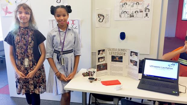 middle school students stand by their project