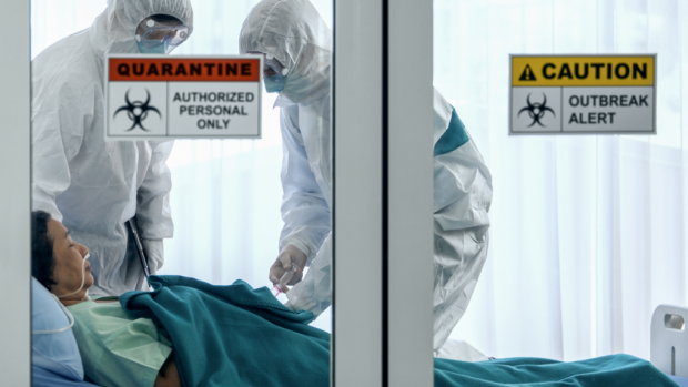 person in quarantined hospital bed