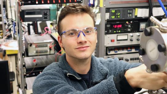 Caspar Lant wearing safety goggles in a lab