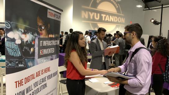 Employer talking to a student at Tandon Career Fair