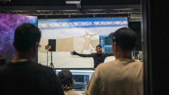 person in front of motion capture wall