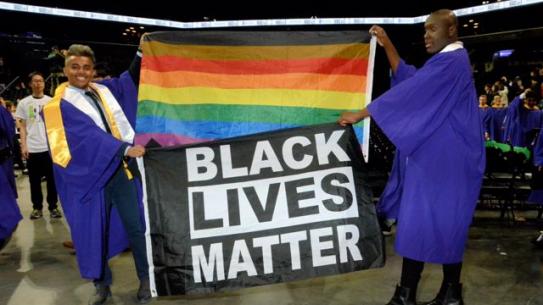 2019 Tandon graduation. Two students holding Black Lives Matter and Pride flags