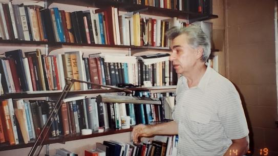 Prof. Youla in front of bookcase