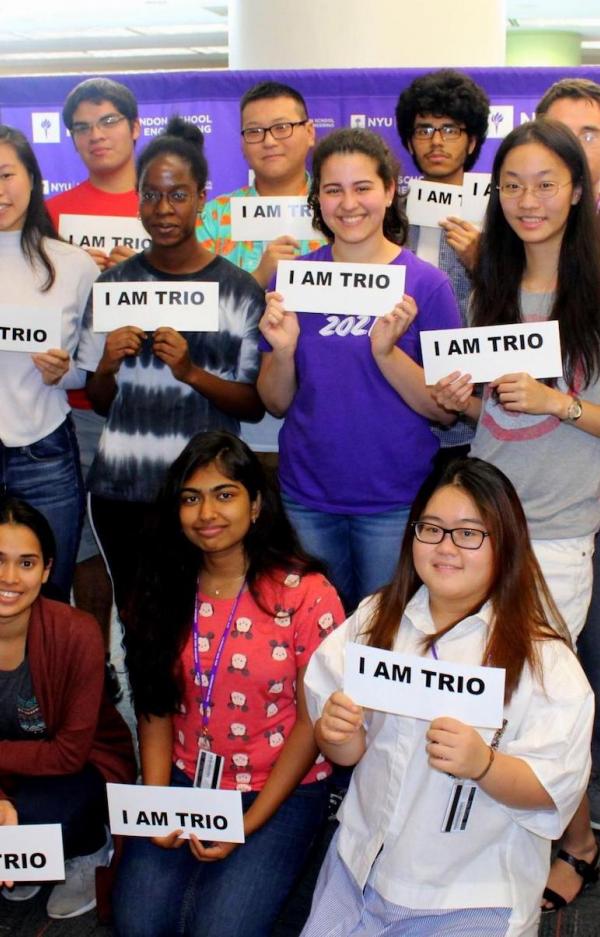 diverse group of students holding signs saying "I am TRIO"