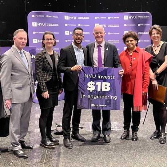 Senior University and School leadership, elected officials, and friends of Tandon with sign saying "NYU invests $1B in engineering"